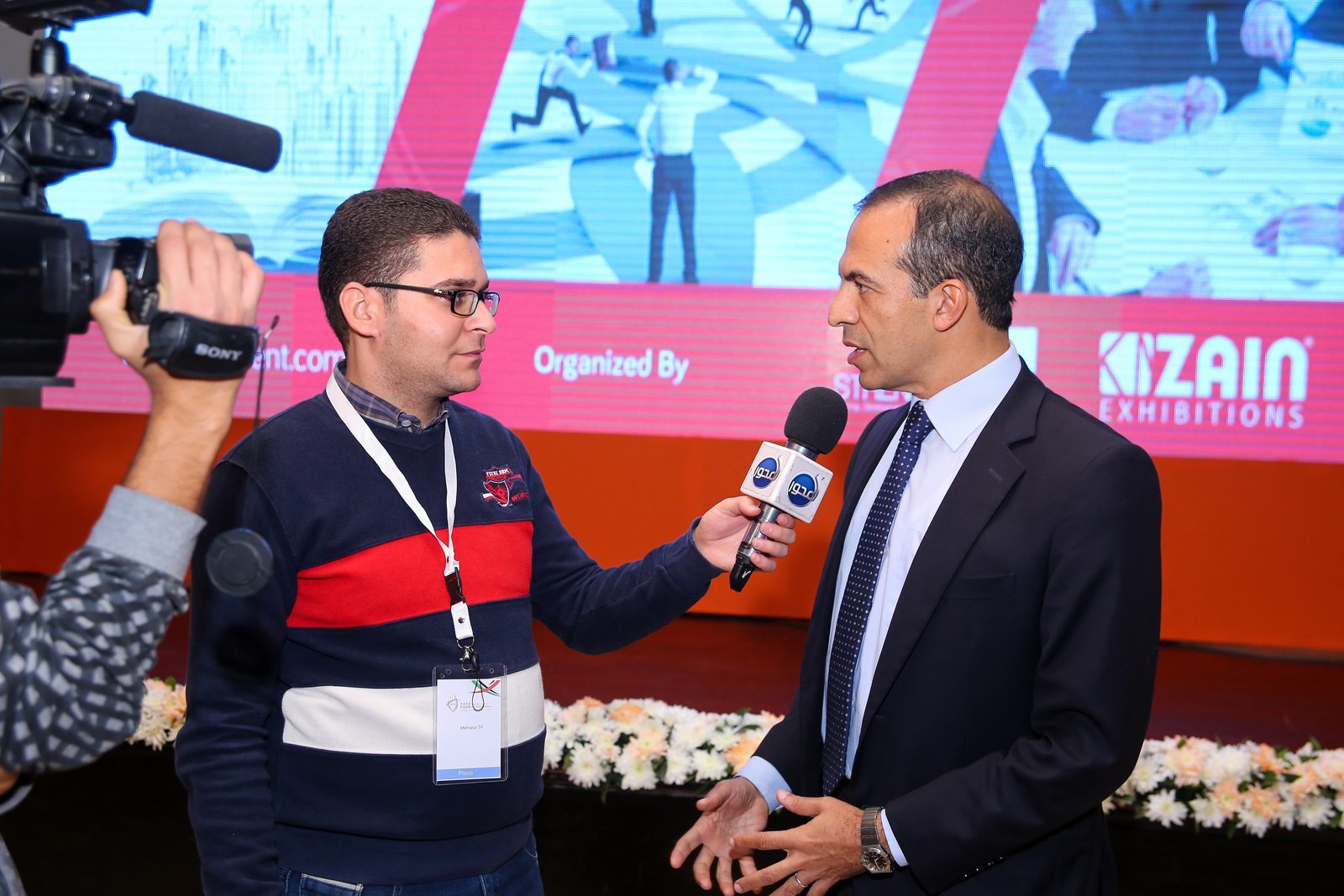 TV interview in front of the AYD 2016 backdrop with the Zain Exhibitions logo