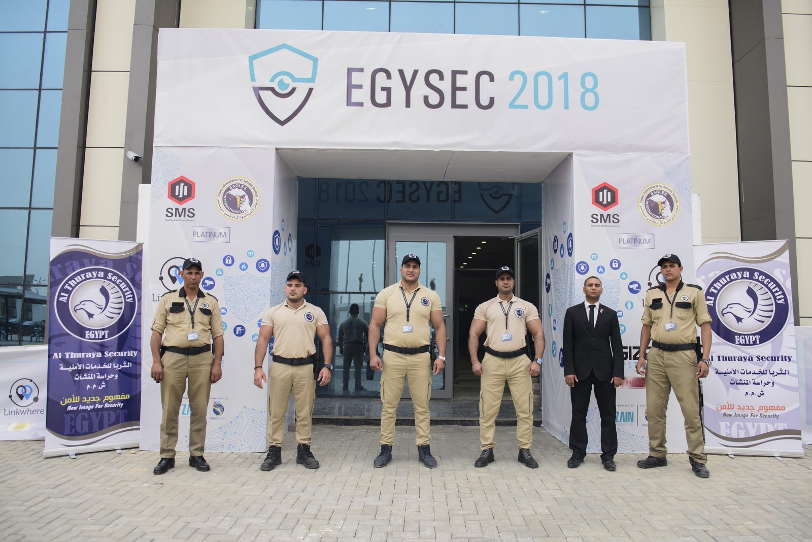 Uniformed security guards at the EGYSEC 2018 entrance arch with sponsor banners