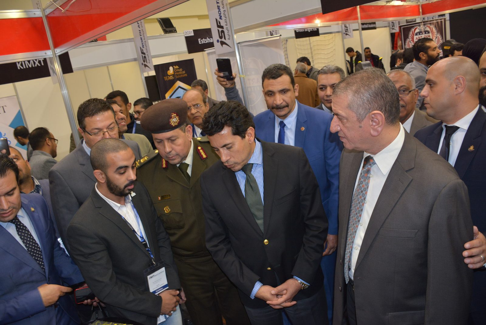 The minister touring exhibitor stands during the opening