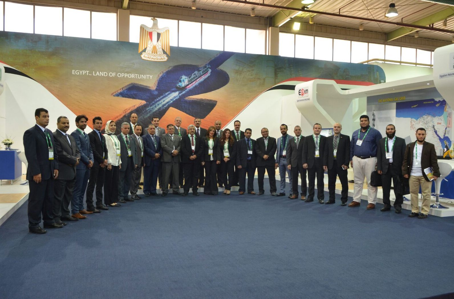 Egyptian delegation in front of the pavilion backdrop reading 'EGYPT.. LAND OF OPPORTUNITY'