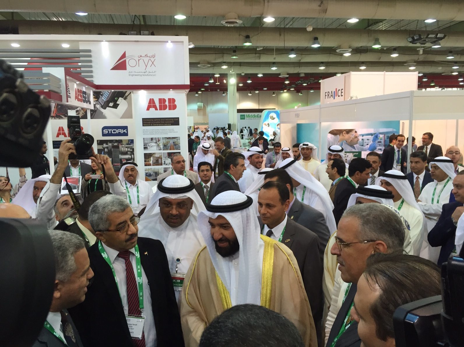 Officials touring the show floor surrounded by delegates and press