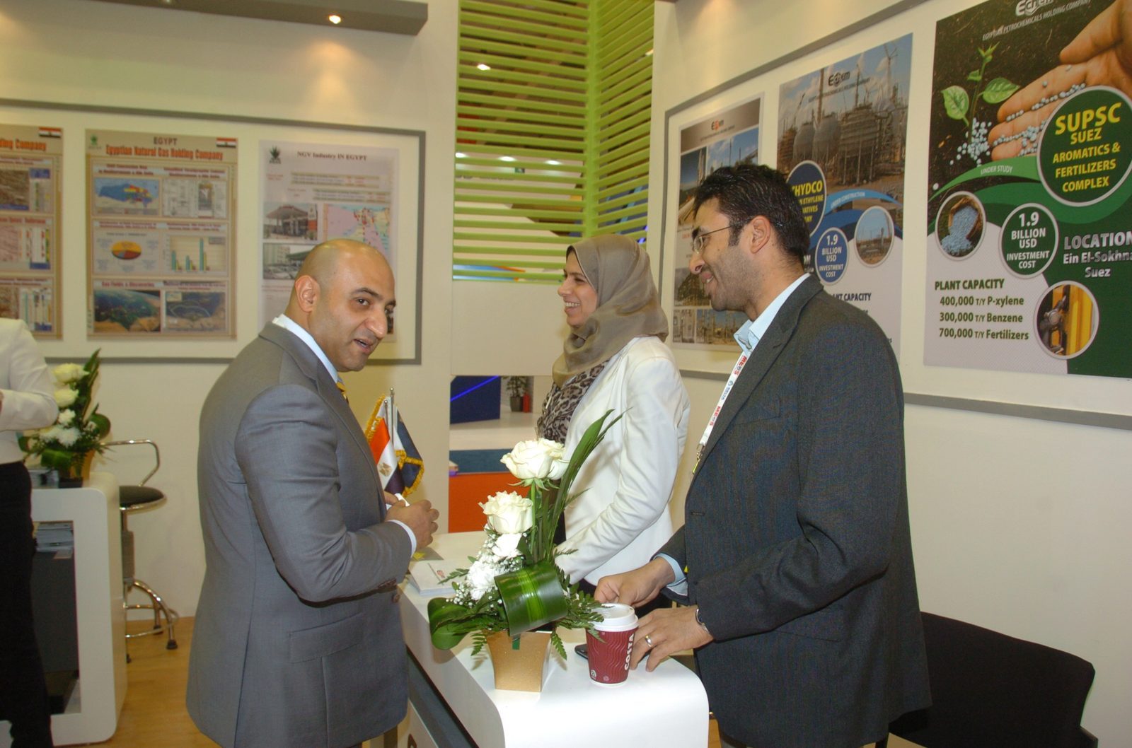 Visitors in conversation at an Egyptian company stand in the pavilion