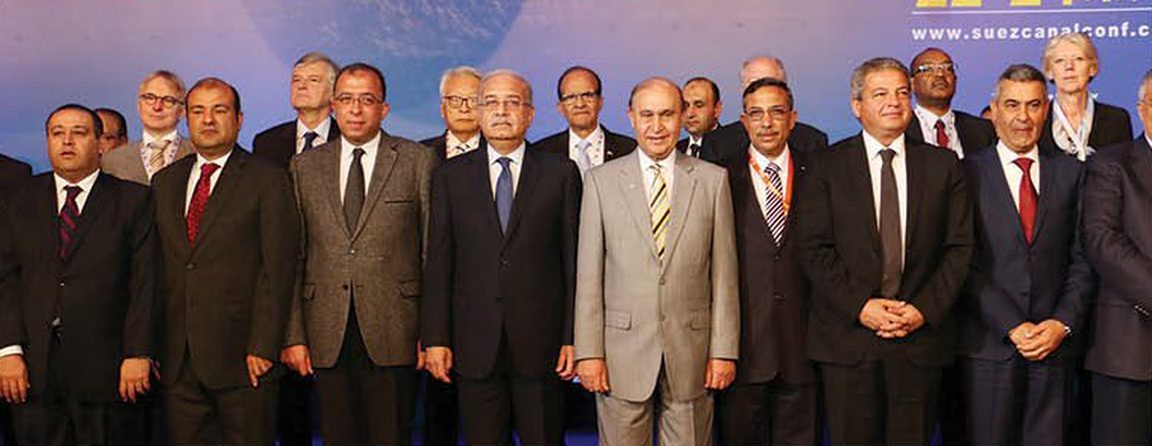 Officials and delegates in front of the Suez Canal Global Conference backdrop (www.suezcanalconf...)
